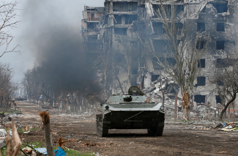  Service members of pro-Russian troops ride an armoured vehicle during fighting in Ukraine-Russia conflict near a plant of Azovstal Iron and Steel Works company in the southern port city of Mariupol, Ukraine April 12, 2022. (credit: Alexander Ermochenko/Reuters)