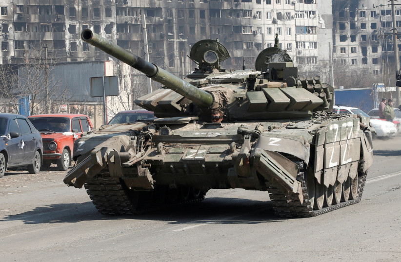  A tank of pro-Russian troops drives along a road near burnt-out residential buildings in the course of Ukraine-Russia conflict in the southern port city of Mariupol, Ukraine April 5, 2022. (credit: Alexander Ermochenko/Reuters)
