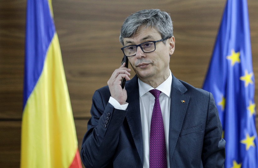 Romanian Energy Minister, Virgil Popescu, talks on the phone before an interview with Reuters, in Bucharest, Romania, January 13, 2022 (photo credit: VIA REUTERS)