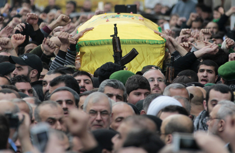  Lebanon's Hezbollah members carry the coffin of Jihad Moughniyah during his funeral in Beirut's suburbs January 19, 2015. The man (bottom C, wearing glasses) is the head of Hezbollah's parliamentary bloc Mohamed Raad. (credit: REUTERS/AZIZ TAHER)