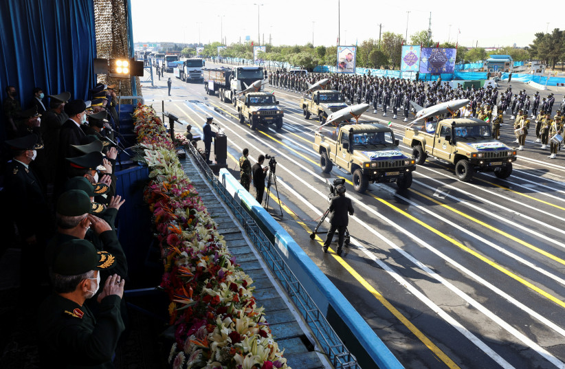  Iranian President Ebrahim Raisi and military commanders watch as military equipment passes by during a ceremony of the National Army Day parade in Tehran, Iran April 18, 2022. (photo credit: PRESIDENT WEBSITE/WANA (WEST ASIA NEWS AGENCY)/HANDOUT VIA REUTERS)