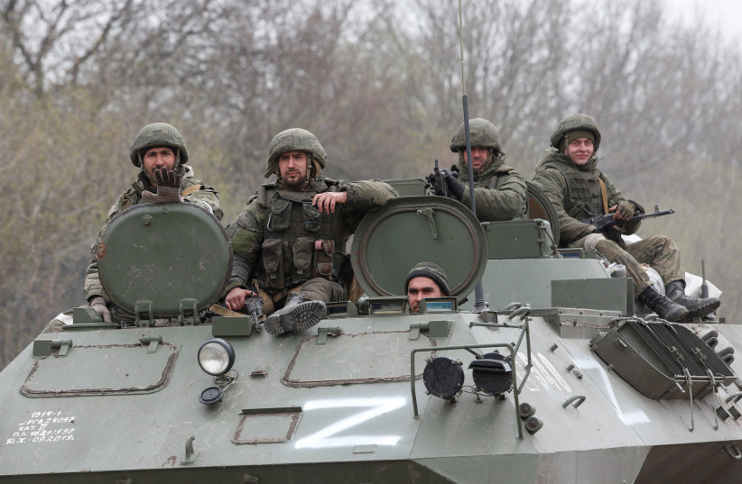 Service members of pro-Russian troops drive an armoured vehicle during Ukraine-Russia conflict near the southern port city of Mariupol, Ukraine April 17, 2022 (photo credit: REUTERS/ALEXANDER ERMOCHENKO)