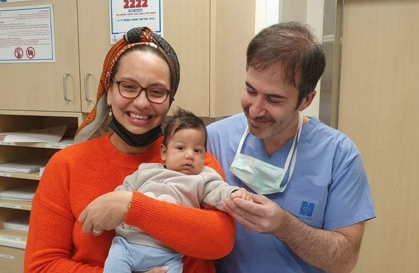  Jennifer Lopez holds her baby alongside Prof. Jose Cohen. (photo credit: HADASSAH SPOKESPERSON)