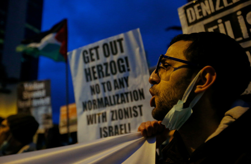 Pro-Palestinian demonstrators take part in a protest against the visit of Israeli President Isaac Herzog, outside the Israeli Consulate in Istanbul, Turkey March 9, 2022.  (credit: REUTERS/DILARA SENKAYA)