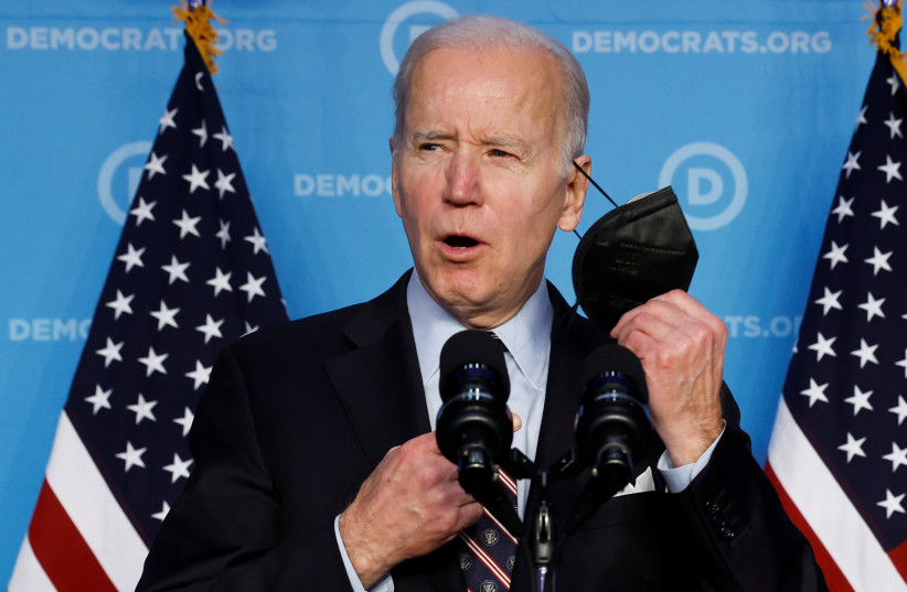  US President Joe Biden removes his face mask as he delivers remarks to the Democratic National Committee (DNC) Winter Meeting in Washington, US, March 10, 2022.  (credit: REUTERS/JONATHAN ERNST)