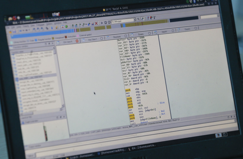  A view shows a laptop display showing part of a code (credit: REUTERS/VALENTYN OGIRENKO)