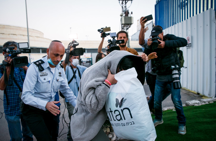 MAUDA, WHO was filmed abusing toddlers, covers her face as she arrives in Neveh Tirza to serve her prison sentence, September 2021. (credit: FLASH90)