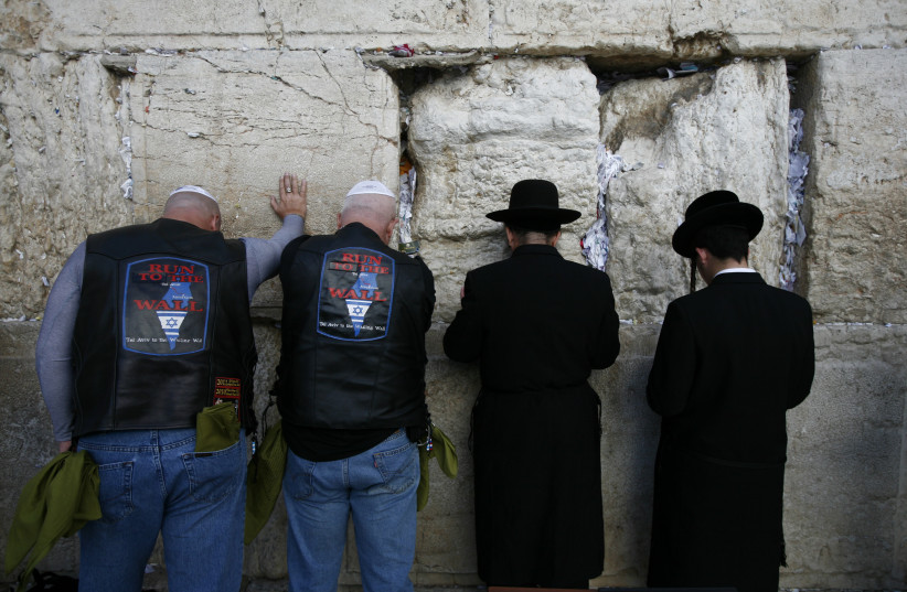  US MOTORCYCLISTS on tour with evangelical pastors, praying next to haredim at the Western Wall.  (photo credit: BAZ RATNER/REUTERS)