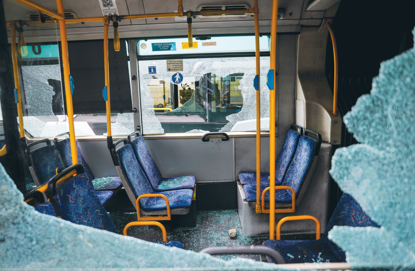  BUS WINDOWS were shattered in a stone-throwing attack this week outside Jerusalem’s Old City. The synthesis of Muslim religious fervor with anti-Israel and antisemitic violence is sadly nothing new. (photo credit: YONATAN SINDEL/FLASH90)