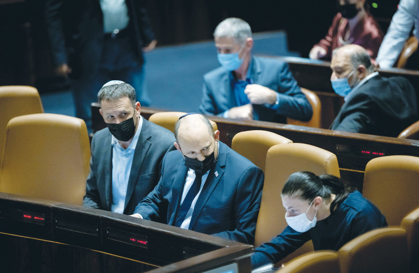  PRIME MINISTER Naftali Bennett sits between Religious Services Minister Matan Kahana and Transportation Minister Merav Michaeli in the Knesset. It’s not surprising that the coalition is made up of liberal religious and secular Jews.  (photo credit: YONATAN SINDEL/FLASH90)