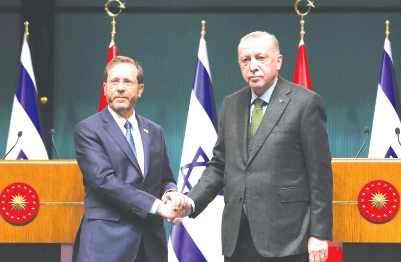  Turkish President Tayyip Erdogan and his Israeli counterpart Isaac Herzog shake hands during a joint new conference in Ankara. (photo credit: PRESIDENTiAL PRESS OFFICE/REUTERS)