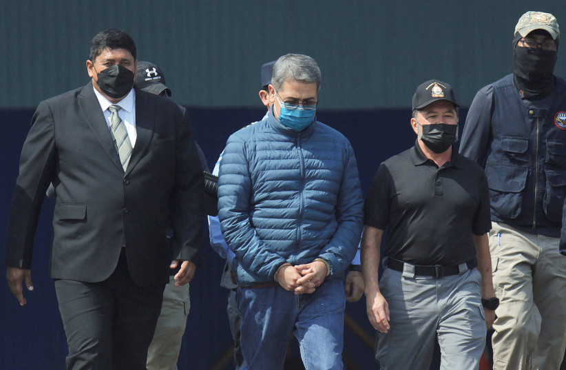  Honduras former President Juan Orlando Hernandez is escorted by authorities as he walks towards a plane of the U.S. Drug Enforcement Administration (DEA) for his extradition to the United States, to face a trial on drug trafficking and arms possession charges, at the Hernan Acosta Mejia Air Force b (credit: REUTERS/FREDY RODRIGUEZ)