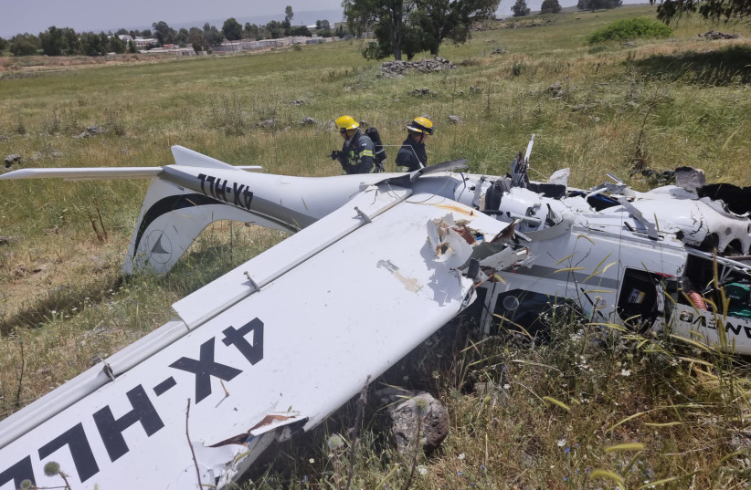 Firefighters attend to a small airplane after it made a crash landing near Rosh Pina on April 23, 2022. (credit: FIRE AND RESCUE NORTHERN DIVISION)
