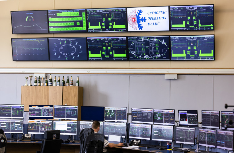 A man works in the European Organization for Nuclear Research (CERN) Control Centre in Meyrin near Geneva, Switzerland, April 13, 2022. (credit: REUTERS/PIERRE ALBOUY)