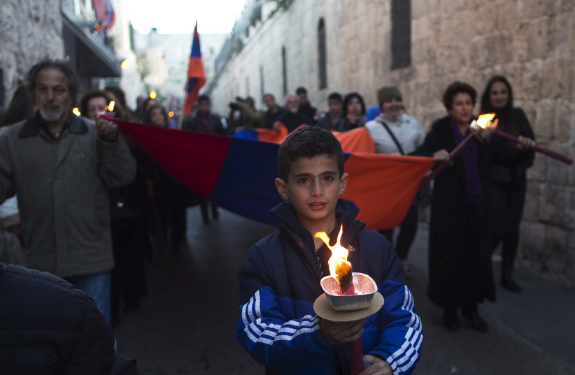  Members of the Armenian community attend a memorial march marking the 100th anniversary of the mass killings of 1.5 million Armenians by Ottoman Turkish forces in Jerusalem's Old City April 23, 2015 (photo credit: RONEN ZVULUN/REUTERS)