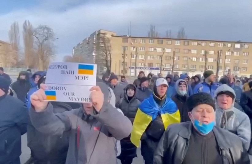  People protest the abduction of Mayor Ivan Fedorov, outside the Melitopol regional administration building, after he was reportedly taken away by Russian forces, during their ongoing invasion, in Melitopol, Ukraine in this still image obtained from handout video released March 12, 2022. (credit: Courtesy of Deputy Head for President's Office, Ukraine/Handout via REUTERS)