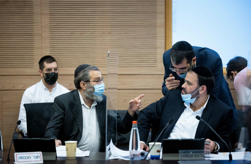  MK's Moshe Gafni and Yinon Azulai attend Finance committee meeting, in the Knesset, the Israeli parliament in Jerusalem on December 7, 2021.  (photo credit: YONATAN SINDEL/FLASH90)