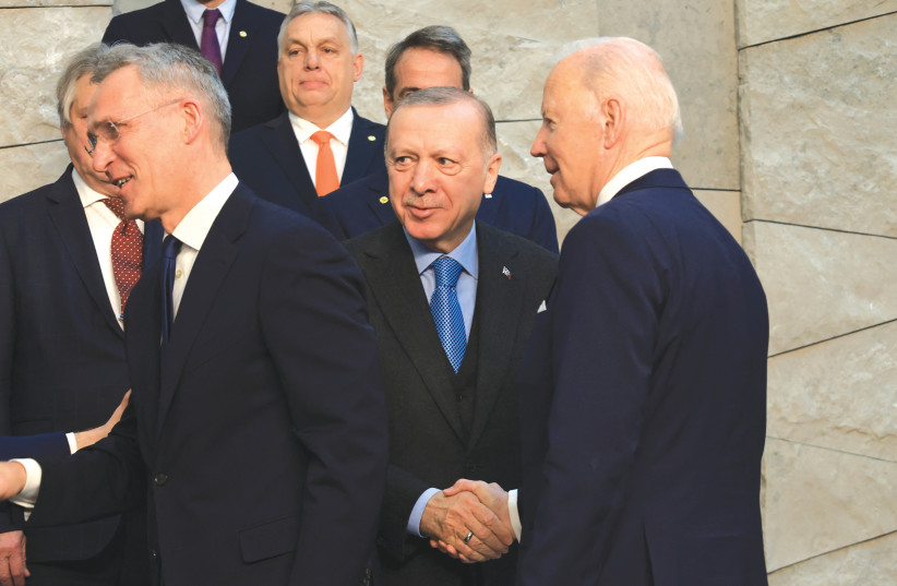  TURKEY’S PRESIDENT Recep Tayyip Erdogan and US President Joe Biden shake hands before a NATO summit in Brussels last month. Whatever tensions exist in US-Turkish relations have more to do with other issues such as Erdogan’s authoritarian actions.  (credit: Wolfgang Rattay/Reuters)