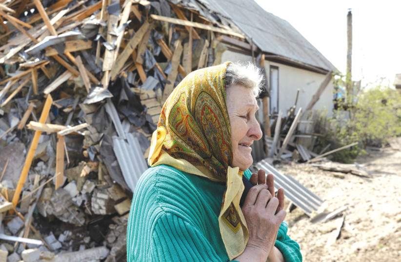  A WOMAN cries in front of a house next to hers that was destroyed by a missile amid Russia’s invasion in Lyman, Ukraine, on Saturday. We have a global responsibility to ask: Are we doing enough? (photo credit: JORGE SILVA / REUTERS)