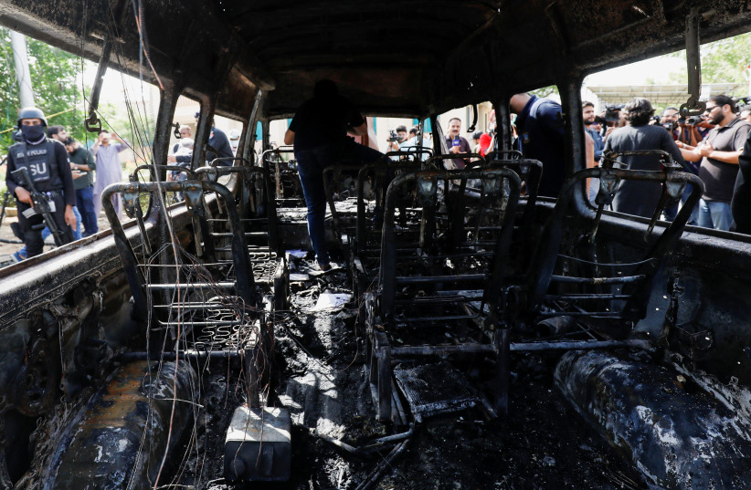  A general view shows a passenger van after a blast at the entrance of the Confucius Institute University of Karachi, Pakistan April 26, 2022. (photo credit: REUTERS/AKHTAR SOOMRO)