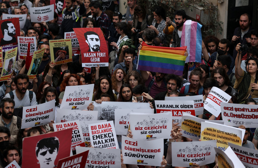  People take part in a protest against a Turkish court decision that sentenced philanthropist Osman Kavala to life in prison over trying to overthrow the government in Istanbul, Turkey, April 26, 2022. (photo credit: REUTERS/UMIT BEKTAS)