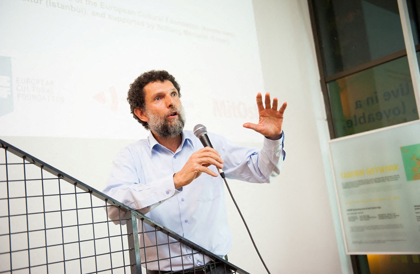  Turkish philanthropist Osman Kavala, accused of attempting to overthrow the government and jailed since late 2017 without a conviction, speaks during an event in this undated handout photo.  (credit: ANADOLU KULTUR/HANDOUT VIA REUTERS)