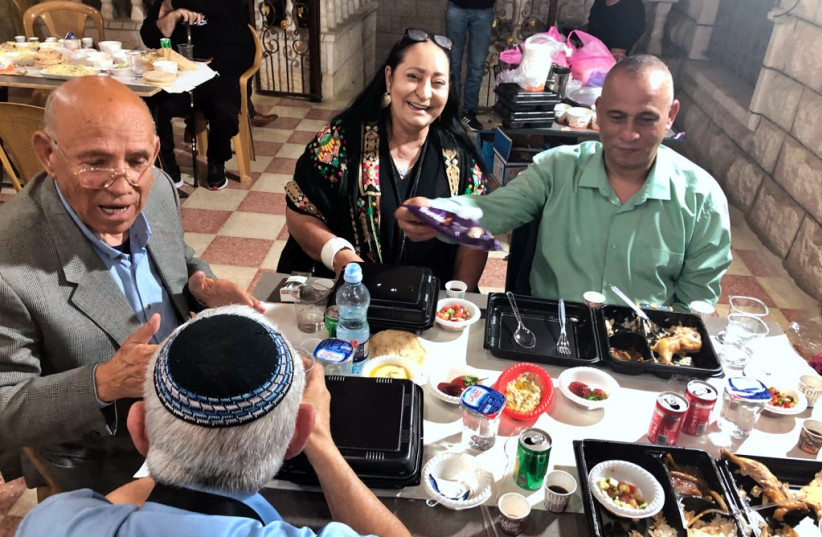 Muhammed Naser, Dina Dagan and Ashraf Jabri at the kosher Iftar celebration in Hebron. (credit: TOVAH LAZAROFF)
