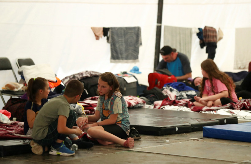 Ukrainians seeking asylum in the United States rest in the Francisco Madero sports complex, set up as a shelter by the local government, in the Iztapalapa neighbourhood in Mexico City, Mexico, April 27, 2022. (credit: REUTERS/EDGARD GARRIDO)