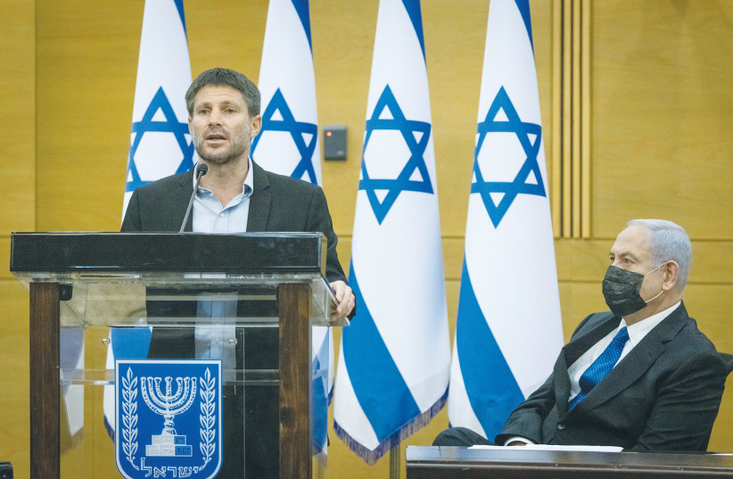  RELIGIOUS ZIONIST PARTY head MK Bezalel Smotrich speaks as opposition leader MK Benjamin Netanyahu looks on at an opposition meeting in the Knesset. (photo credit: YONATAN SINDEL/FLASH90)