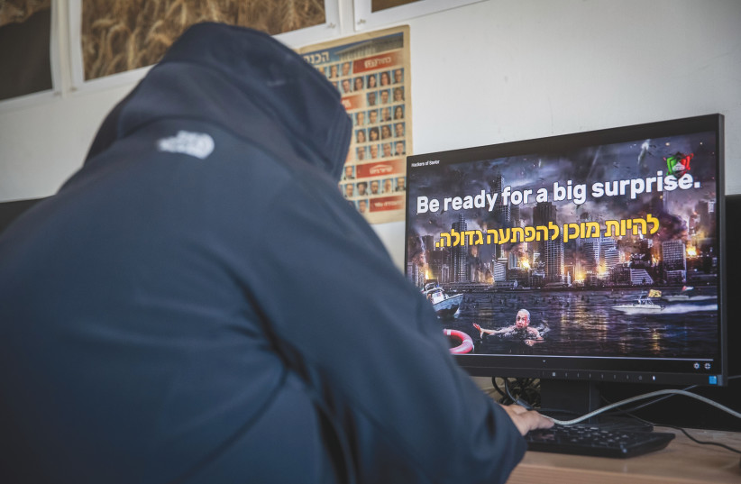  A MAN LOOKS at a video on an Israeli website that was hacked last year by an Iran-based hackers group that calls itself ‘Hacking Saviours.’ (photo credit: YONATAN SINDEL/FLASH90)