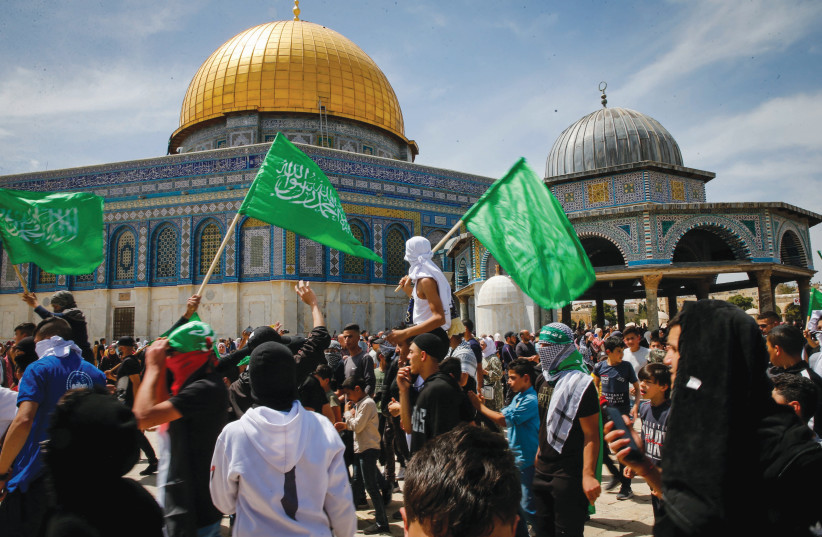  WAVING HAMAS flags after Ramadan prayers on the Temple Mount in Jerusalem, April 22. Occupationalists seems to side with Hamas and not with peaceful Muslim worshipers. (photo credit: JAMAL AWAD/FLASH90)