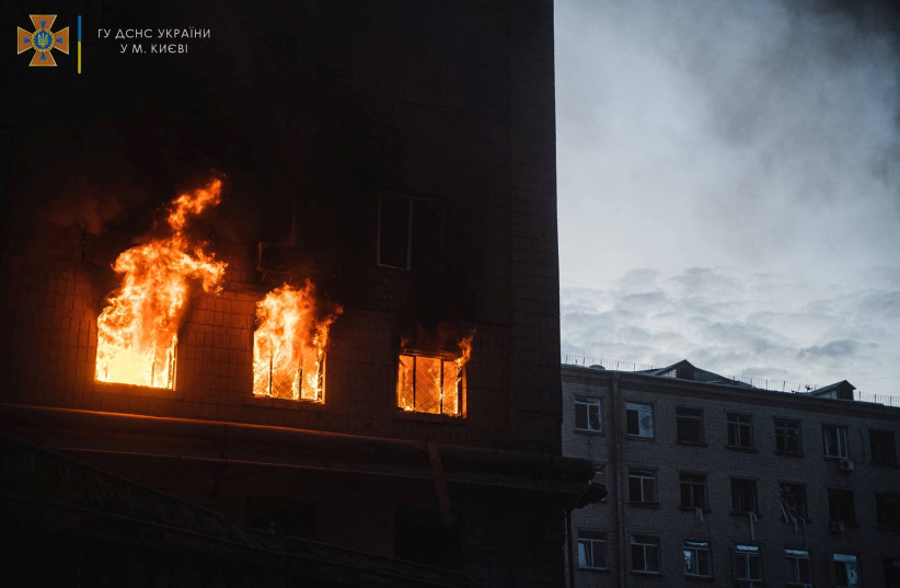  Fire burns in a building damaged by a missile strike, as Russia's attack on Ukraine continues, in Kyiv, Ukraine, in this handout picture released on April 29, 2022.  (credit: Press service of the State Emergency Service of Ukraine/Handout via REUTERS)
