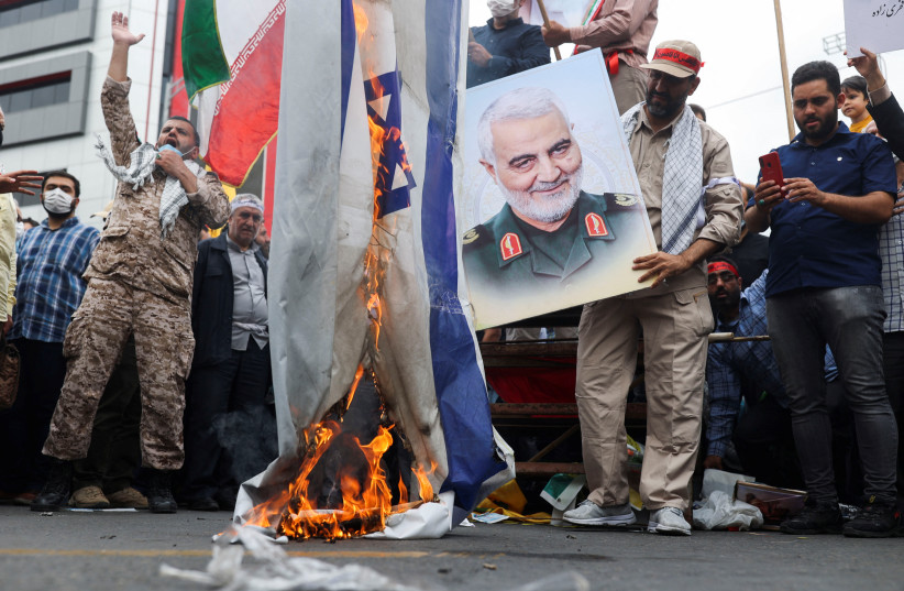 Iranians burn Israeli and US flags during a rally marking the annual Quds Day, or Jerusalem Day, on the last Friday of the holy month of Ramadan in Tehran, Iran April 29, 2022 (credit: WANA NEWS AGENCY/REUTERS)
