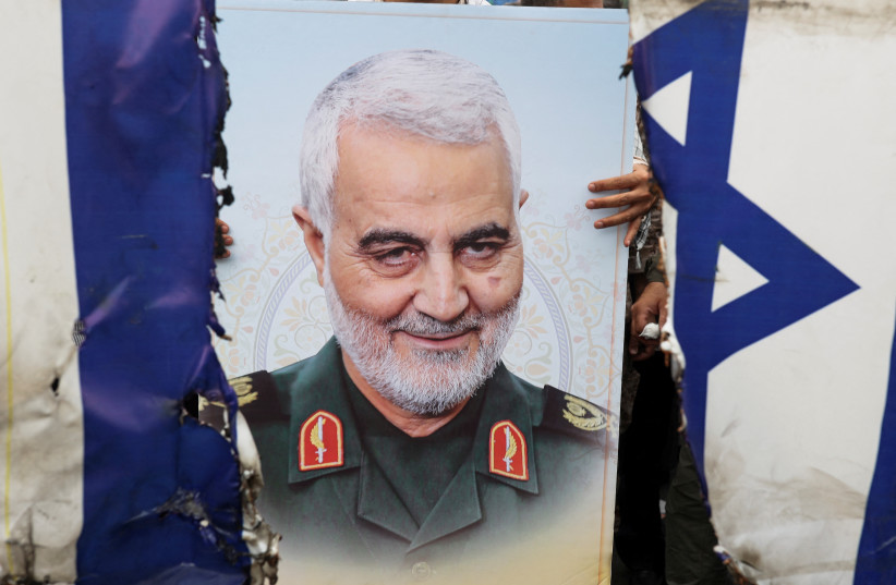 A poster of senior Iranian military commander General Qassem Soleimani is seen during a rally marking the annual Quds Day, or Jerusalem Day, on the last Friday of the holy month of Ramadan in Tehran, Iran April 29, 2022 (photo credit: WANA NEWS AGENCY/REUTERS)