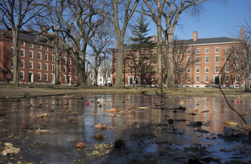 Buildings in Harvard Yard are reflected in frozen puddle at Harvard University in Cambridge, Massachusetts, January 20, 2015. (credit: REUTERS/BRIAN SNYDER)