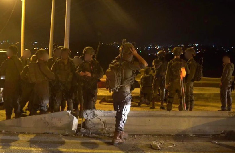IDF soldiers prepare for action after a man was killed in a drive by shooting at the entrance to Ariel on April 29, 2022. (photo credit: IDF SPOKESPERSON'S UNIT)