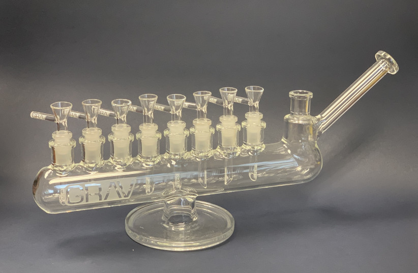  A glass bong in the shape of a menorah is featured in “Am Yisrael High: The Story of Jews and Cannabis,” an new exhibit at YIVO opening May 5, 2022.  (photo credit: YIVO/JTA)