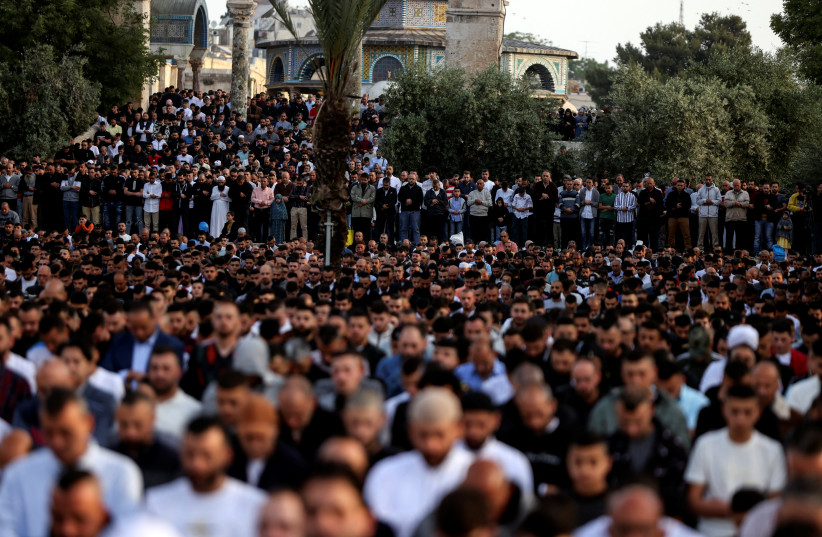 Palestinians attend Eid al-Fitr prayers which marks the end of the holy fasting month of Ramadan, on the compound known to Muslims as Noble Sanctuary and to Jews as Temple Mount in Jerusalem's Old City May 2, 2022. (credit: REUTERS/AMMAR AWAD)
