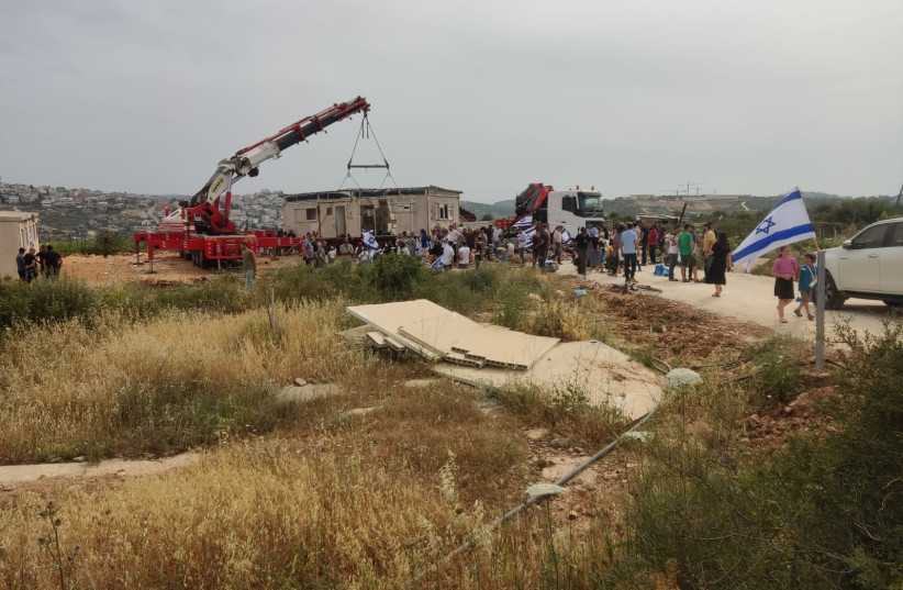  Dozens of settlers came to the site of the modular homes in hopes of swaying the IDF to allow the structures to remain. (photo credit: HaKav HaAdom)