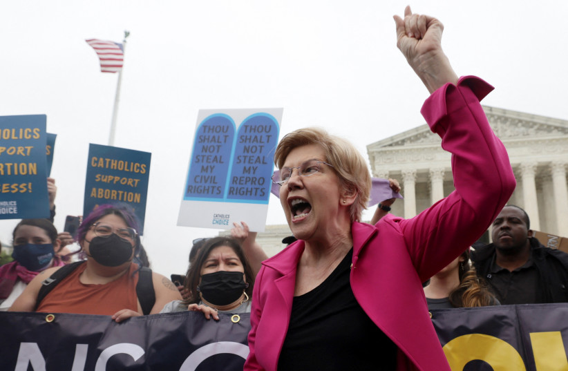 US Senator Elizabeth Warren (D-MA) joins demonstrators during a protest outside the US Supreme Court, after the leak of a draft majority opinion written by Justice Samuel Alito preparing for a majority of the court to overturn the landmark Roe v. Wade abortion rights decision later in 2022. (photo credit: REUTERS/EVELYN HOCKSTEIN)