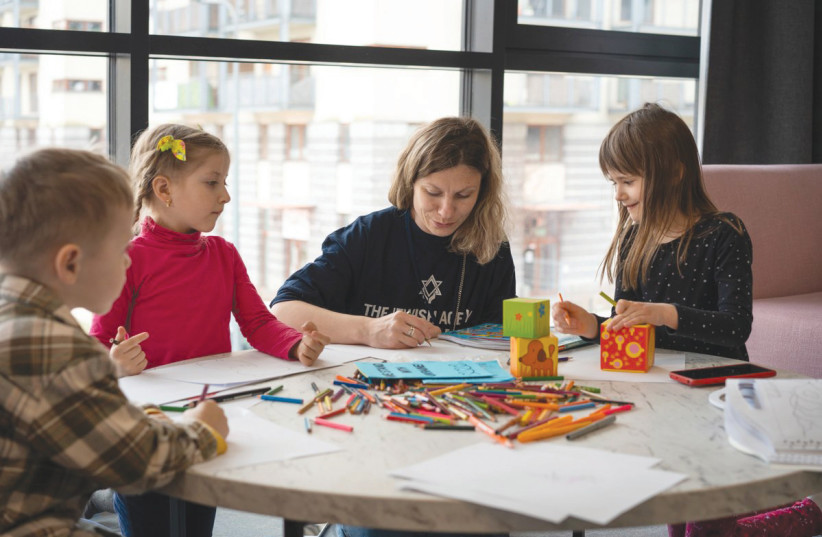 A Jewish Agency volunteer leads an arts and crafts session with refugee children in one of the organization’s Aliyah Centers along the Ukraine border earlier this year.  (photo credit: MAXIM DINSTEIN/JEWISH AGENCY )