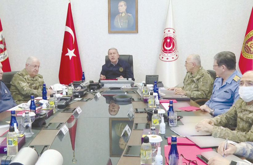Turkish Defense Minister Hulusi Akar speaks during a meeting with military personnel at a command center in Ankara last month, as Turkey said its warplanes hit Kurdish targets in northern Iraq. (photo credit: TURKISH DEFENCE MINISTRY/HANDOUT VIA REUTERS)