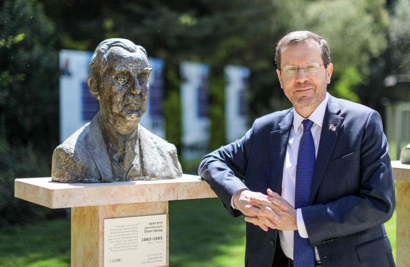  Herzog stands beside the statue of his father, Chaim Herzog, in the gardens of Beit Hanassi.  (photo credit: MARC ISRAEL SELLEM/THE JERUSALEM POST)