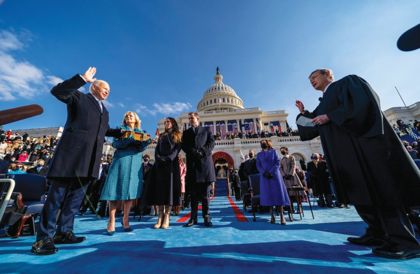  JOE BIDEN is sworn in as the 46th president of the United States as wife Jill holds the Bible, in Washington last year. The book analyzes the Bible and the brain.  (photo credit: ANDREW HARNIK/POOL VIA REUTERS)