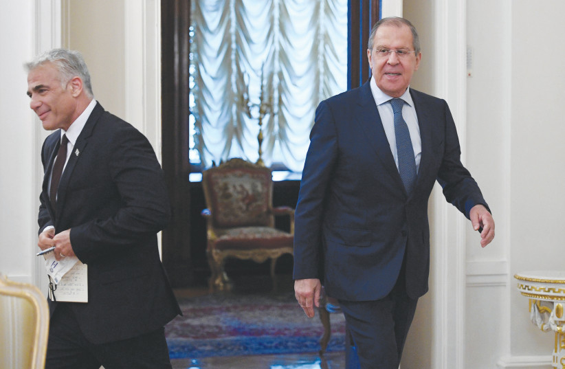  RUSSIAN FOREIGN Minister Sergei Lavrov and his Israeli counterpart, Yair Lapid, enter a hall during a meeting in Moscow, last year in friendlier times. (credit: ALEXANDER NEMENOV/REUTERS)