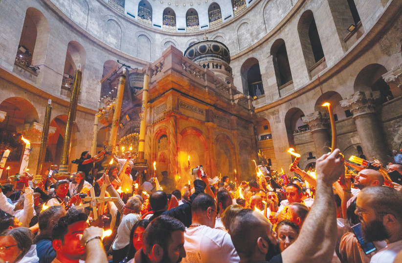  ORTHODOX CHRISTIAN worshippers take part in the Holy Fire ceremony at the Church of the Holy Sepulchre in Jerusalem’s Old City last month. (photo credit: OLIVIER FITOUSSI/FLASH90)
