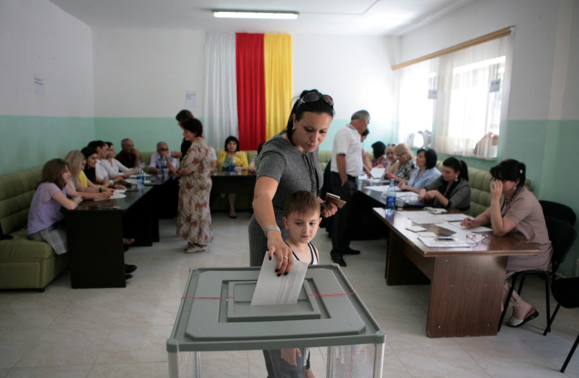  A woman votes during a parliamentary election in Tskhinvali, the capital of the breakaway region of South Ossetia, Georgia, June 9, 2019. (photo credit: Kazbek Basayev/Reuters)