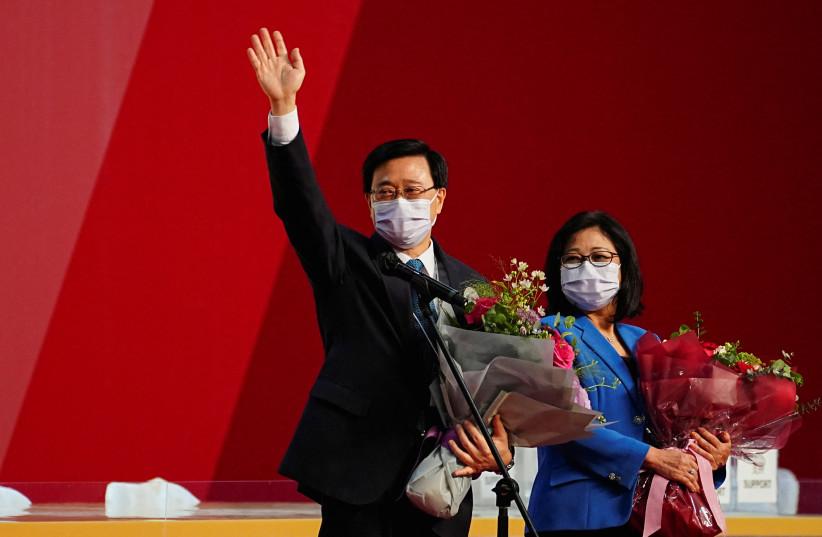  John Lee waves next to his wife Janet Lam Lai-sim after he was elected as Hong Kong's Chief Executive, in Hong Kong, China, May 8, 2022. (photo credit: REUTERS/LAM YIK)