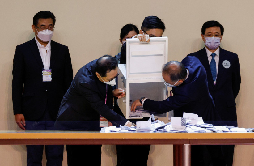  Hong Kong's only Chief Executive candidate John Lee looks on as officials open ballot boxes during the election of Hong Kong's next Chief Executive, in Hong Kong, China, May 8, 2022. (credit: REUTERS/TYRONE SIU)