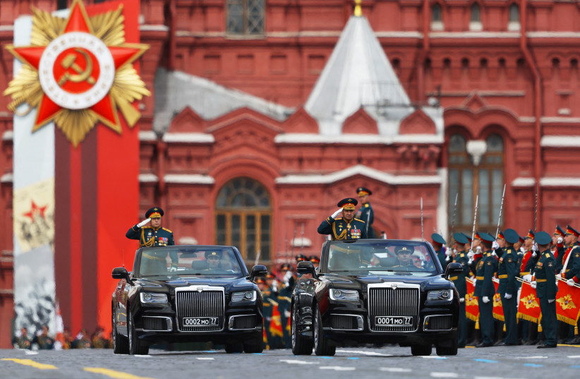  Russian Defence Minister Sergei Shoigu and Chief of the Russian Land Forces Oleg Salyukov drive Aurus cabriolets during a military parade on Victory Day, which marks the 77th anniversary of the victory over Nazi Germany in World War Two, in Red Square in central Moscow, Russia May 9, 2022. (photo credit: REUTERS/EVGENIA NOVOZHENINA)